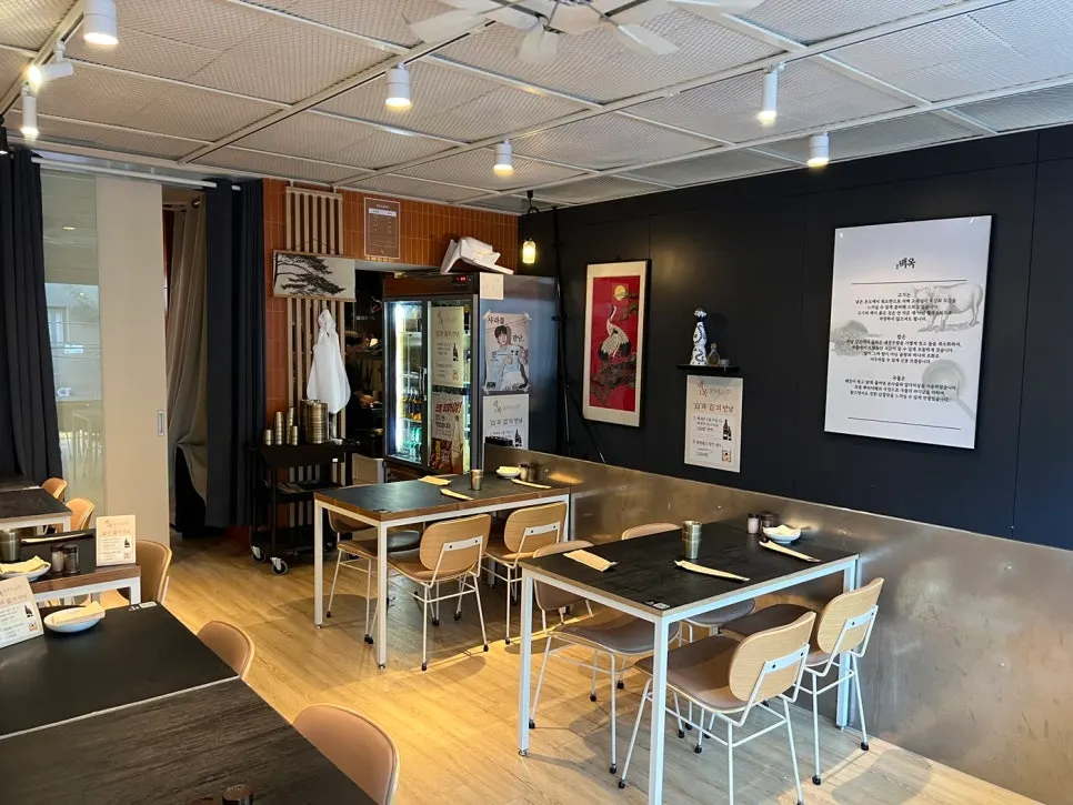 Interior of Baekok Yongsan with orange-toned tiles and wood-tone tables
