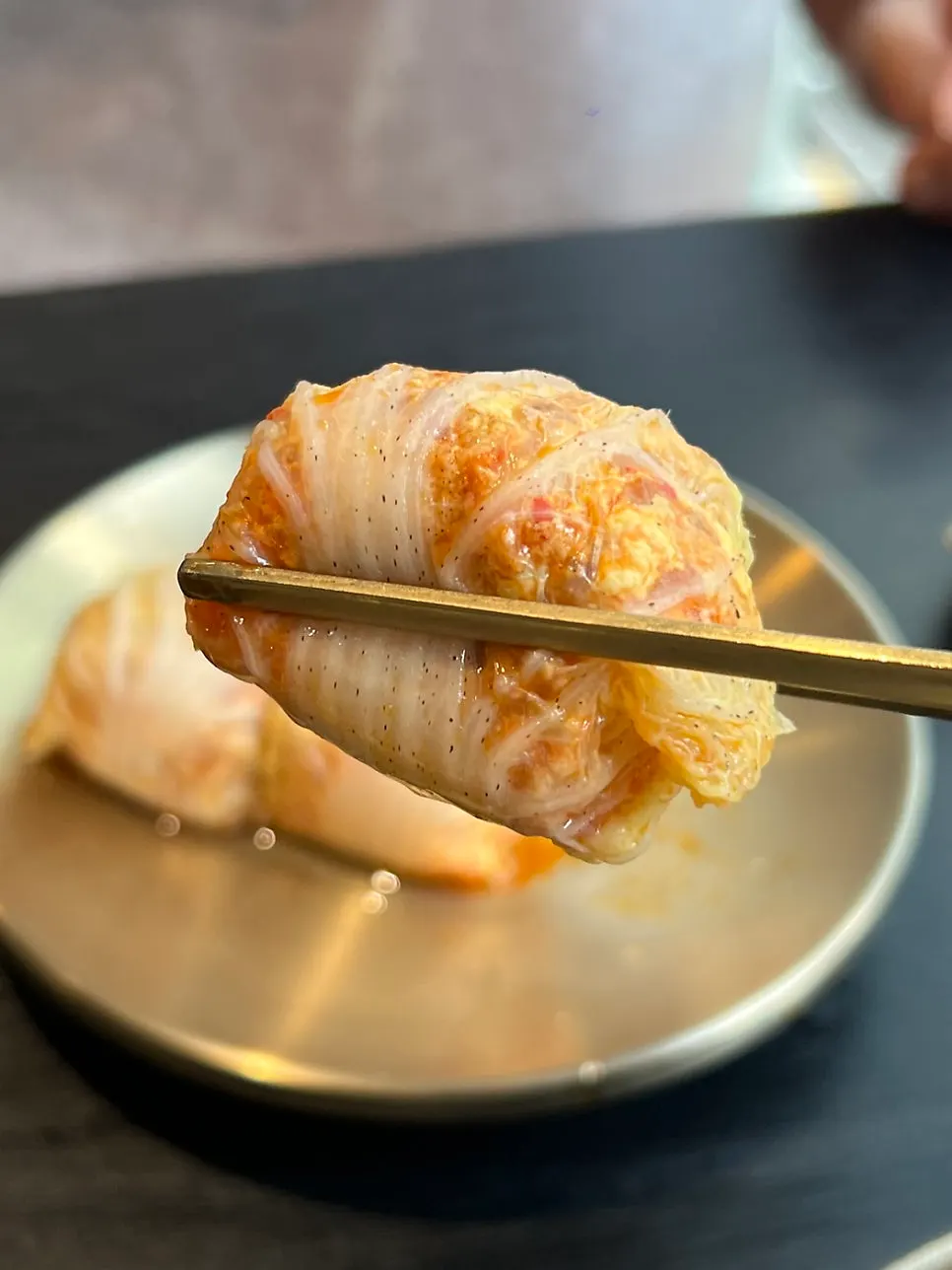 A spoonful of pork gomtang with several slices of meat