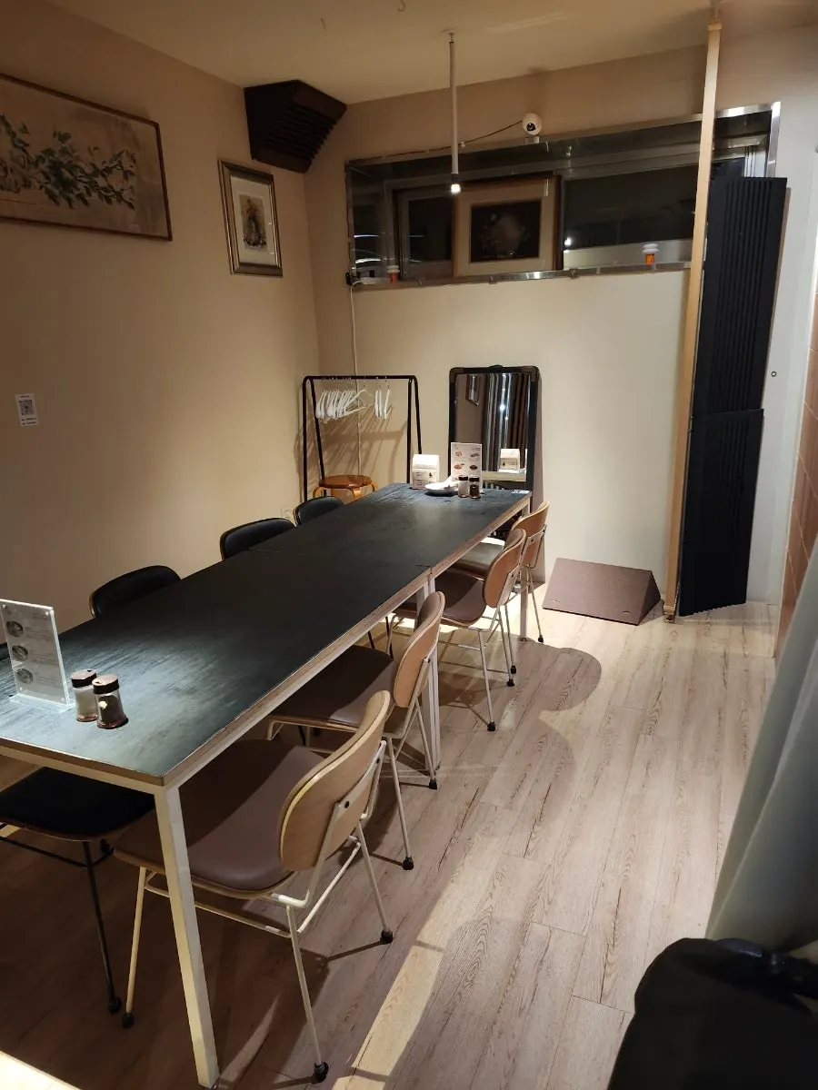 Sectioned space with a long table for several people to sit around