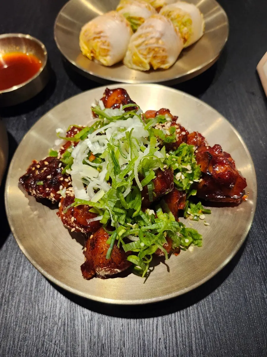 Spicy pig tail topped with scallion and sesame seeds