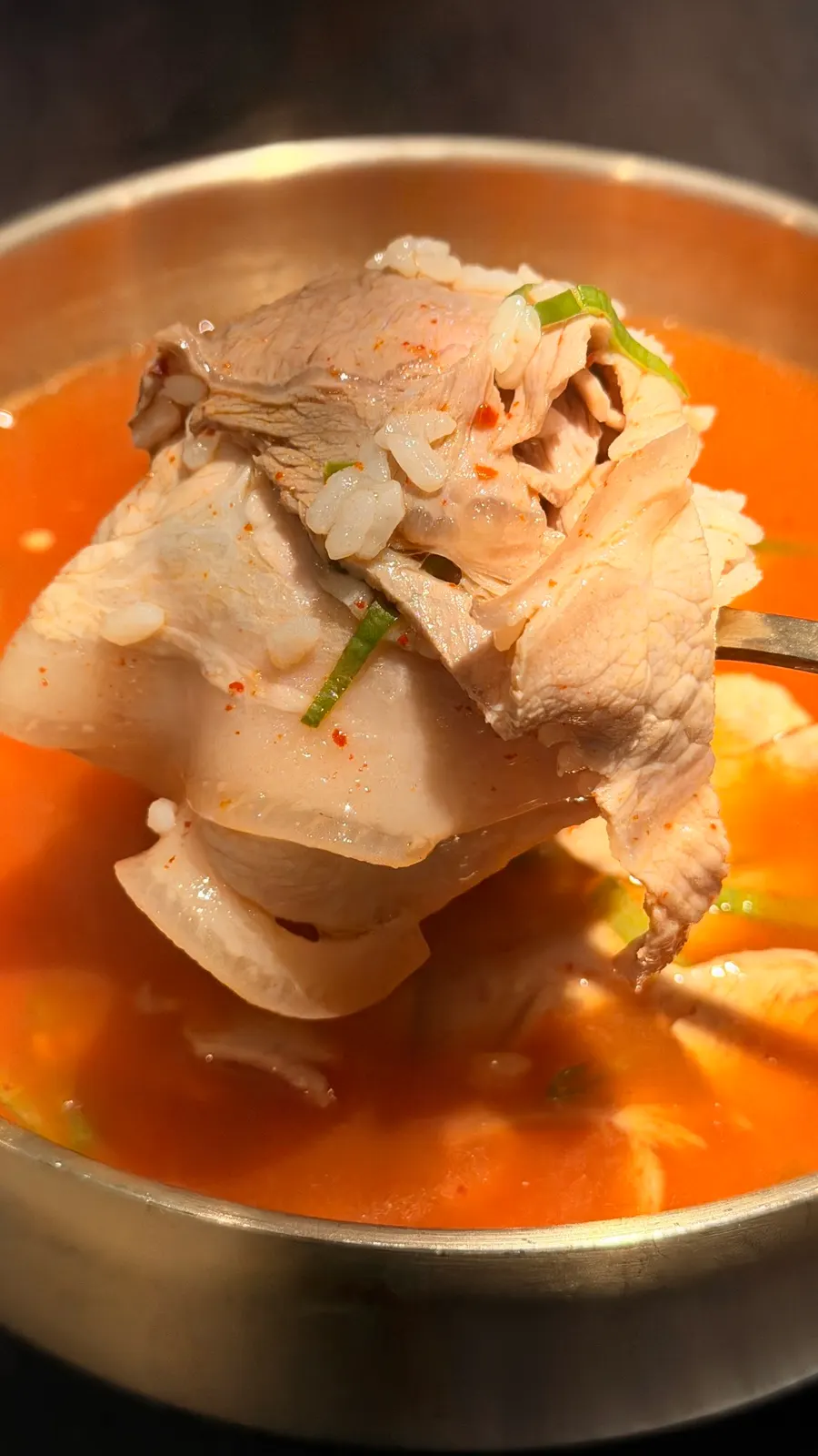 A bowl of gomtang with thinly sliced pork
