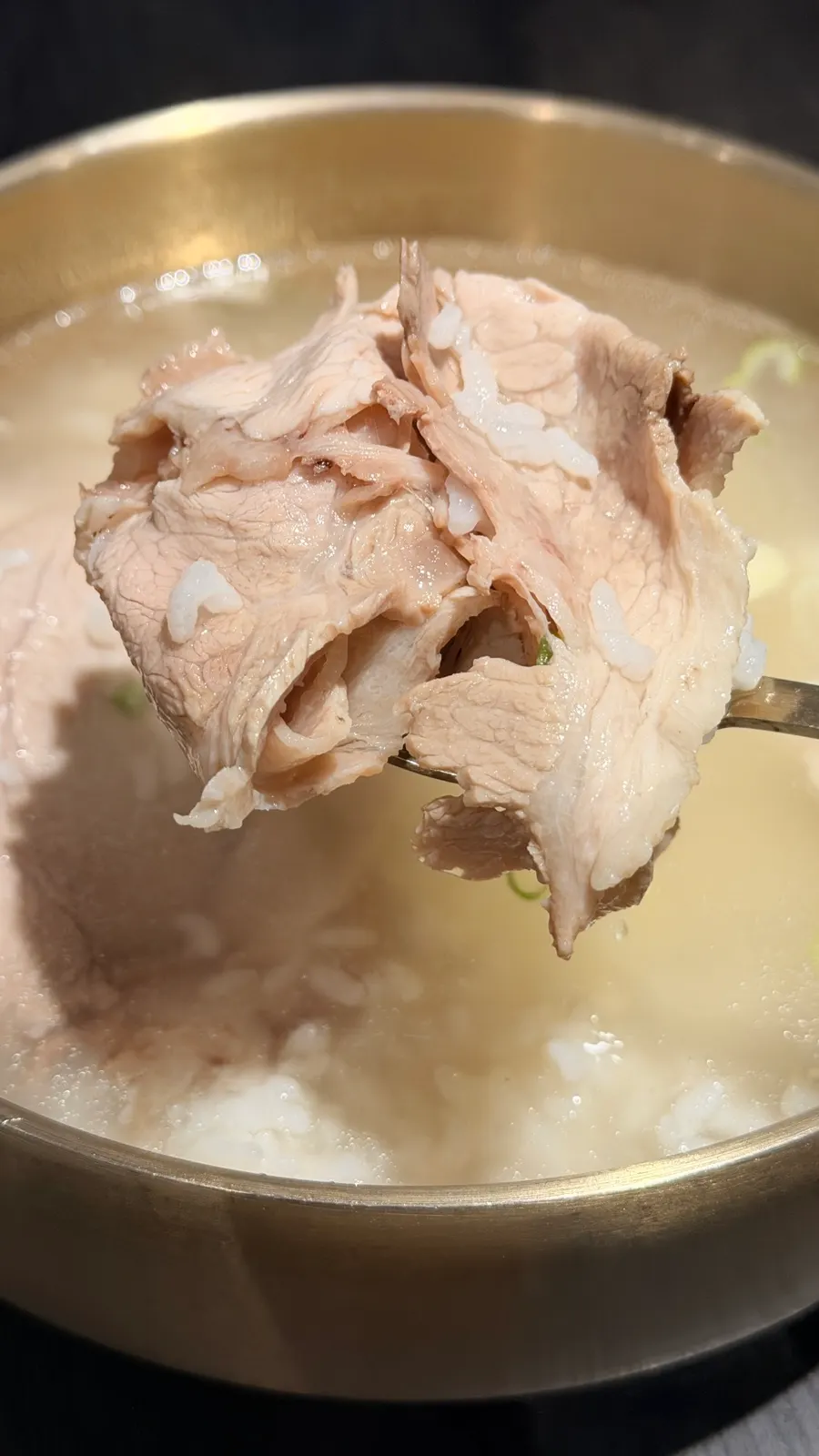 Close-up of pork gomtang with a clear, milky-white broth