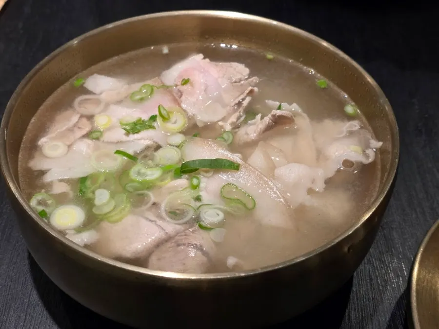 Pork gomtang served in a brass bowl