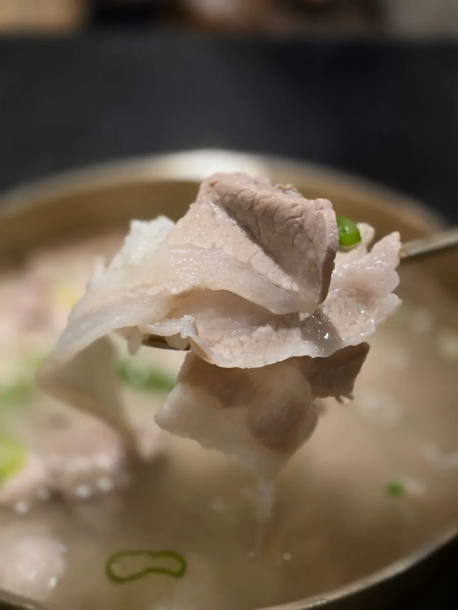 Close-up of Baekok Yongsan's milky pork gomtang broth