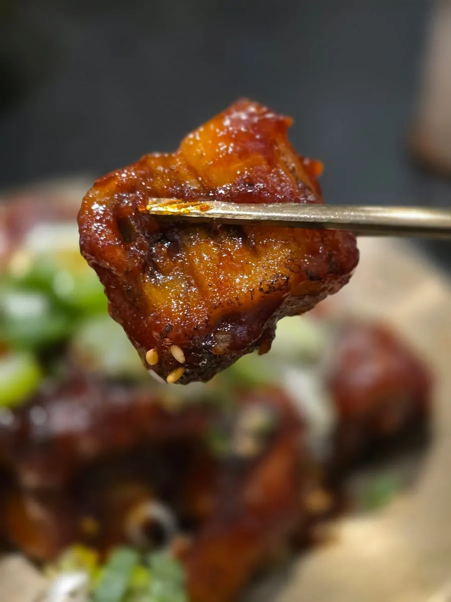 Picking up a piece of the spicy pig tail