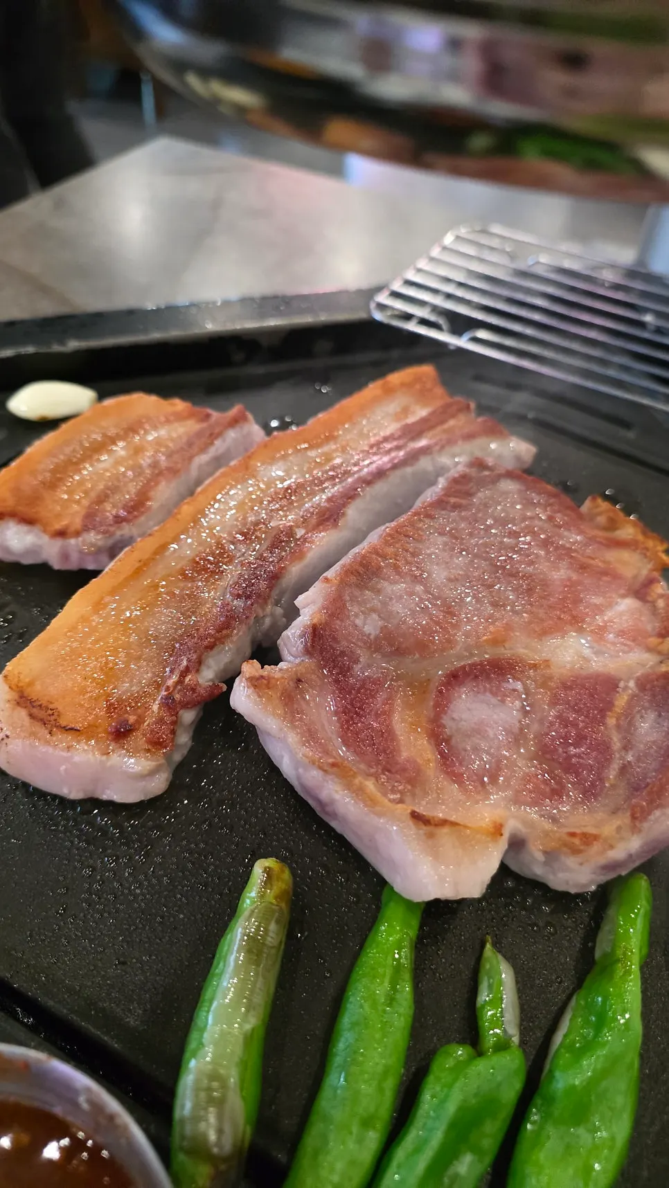 Table spread of Baeksan Hwarro aged pork belly and pork jowl