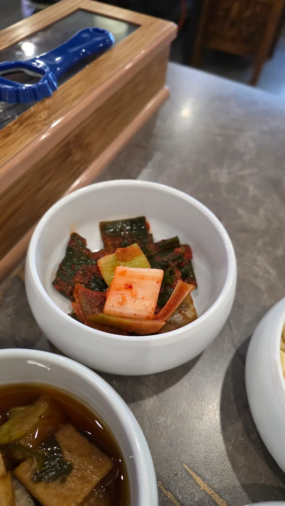 Side dishes including baek-kimchi and macaroni salad