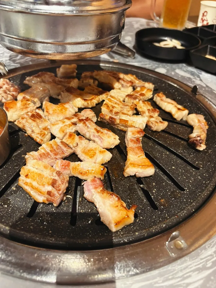 Fresh pork rib cut into bite-sized pieces while grilling