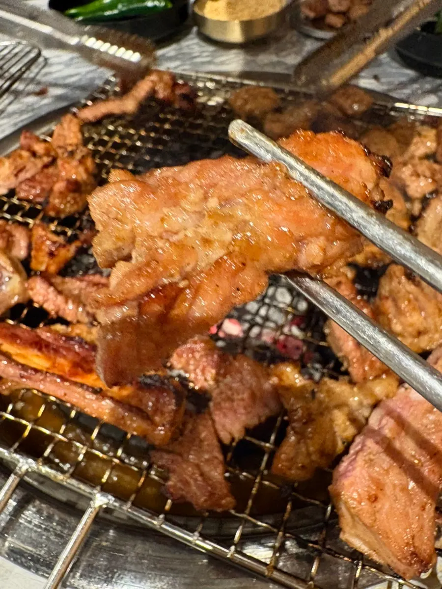 Marinated jinjja dwaeji galbi grilling over charcoal