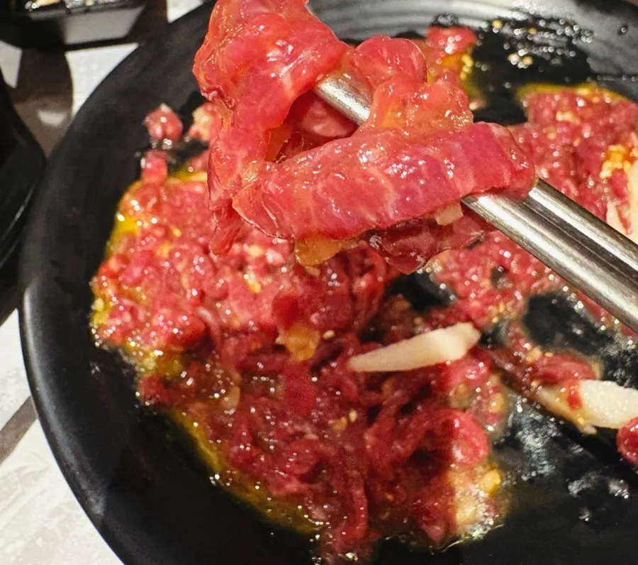 Plate of yukhoe topped with an egg yolk