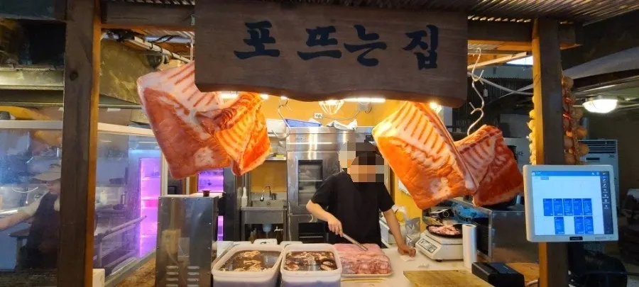 Kitchen area showing meat prep and pre-grilling space