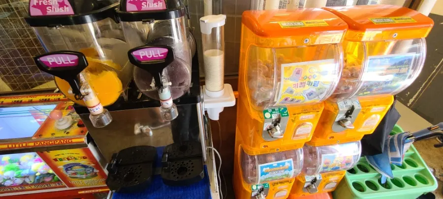 Kids' play area with a claw machine and arcade games