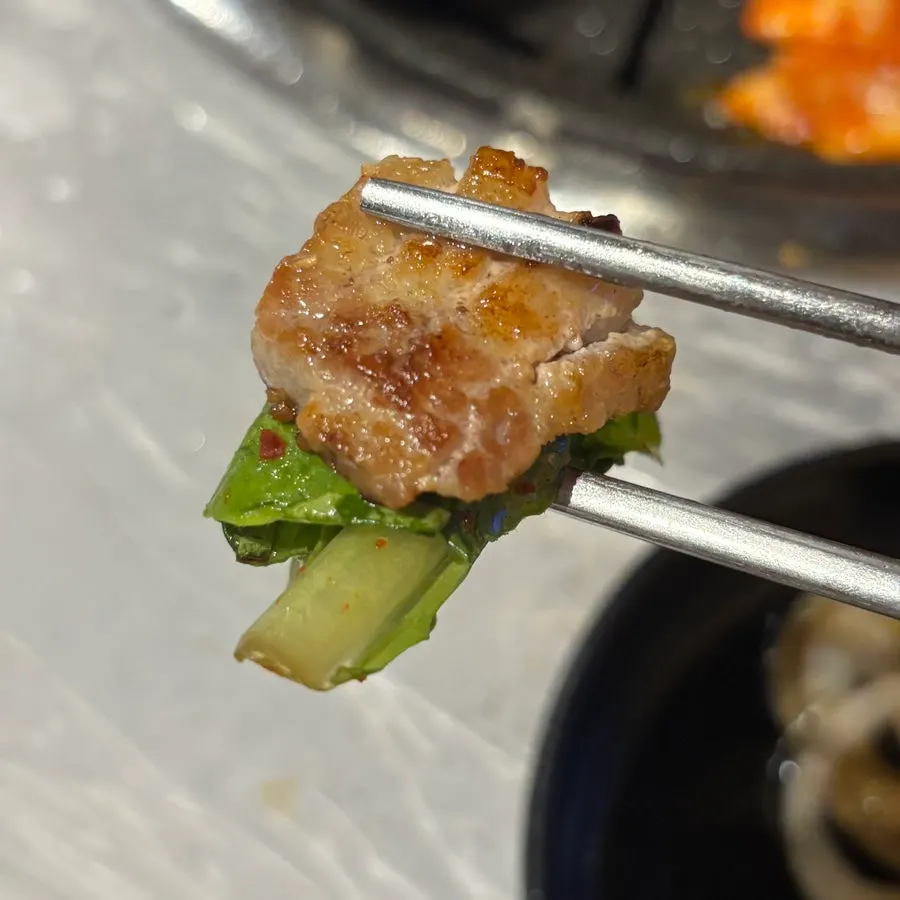 A piece of raw galbi with charcoal aroma