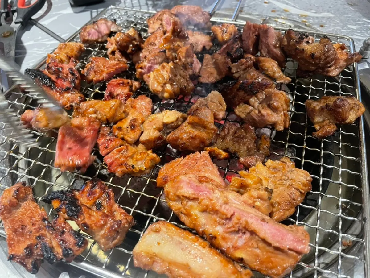 Marinated pork galbi grilling golden brown over charcoal