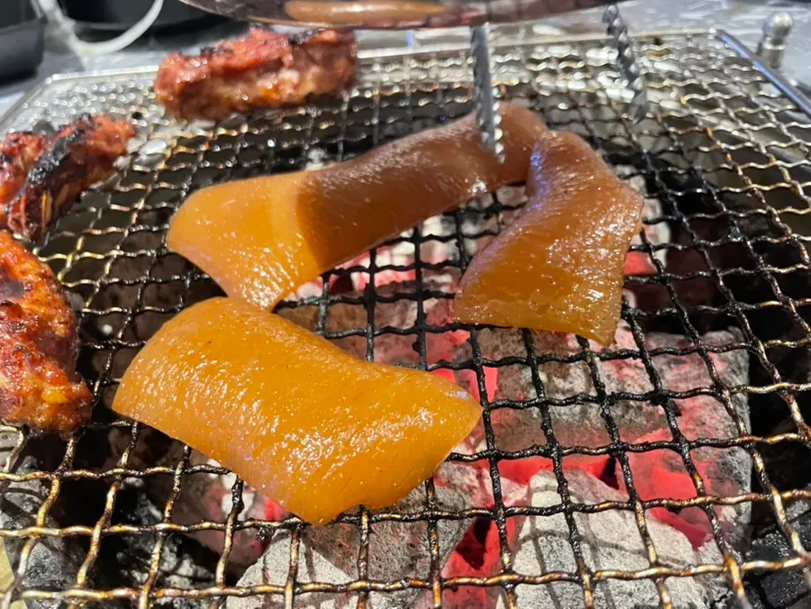 Pork skin placed on the charcoal grill