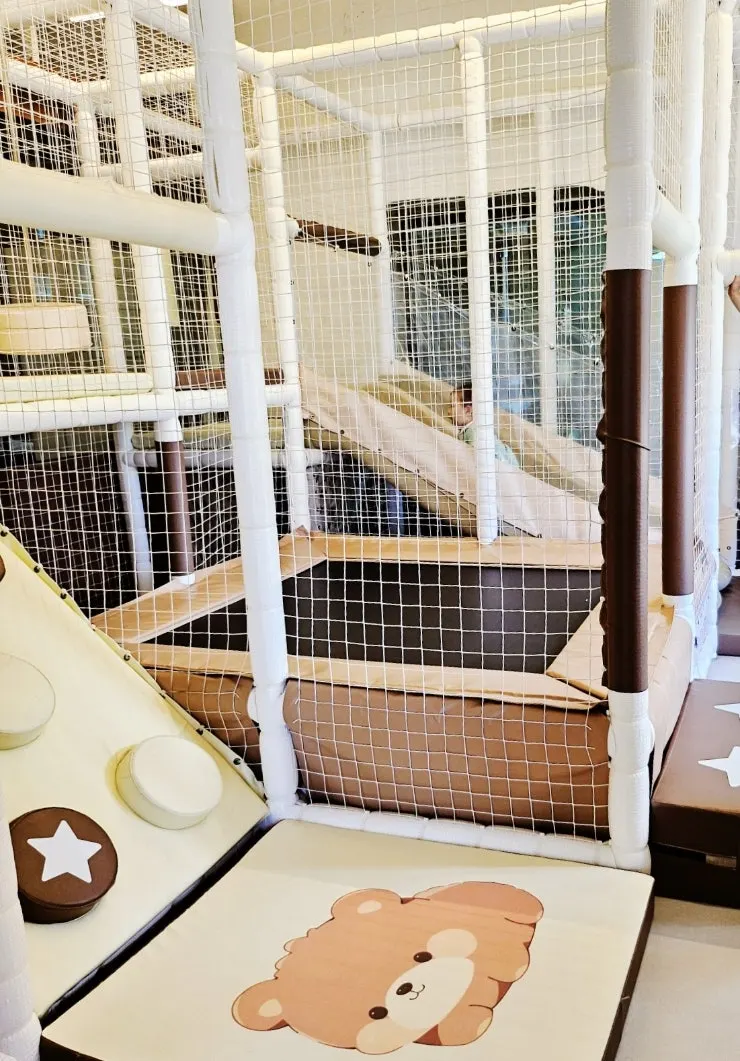 Inside the playroom with a slide and punching bag