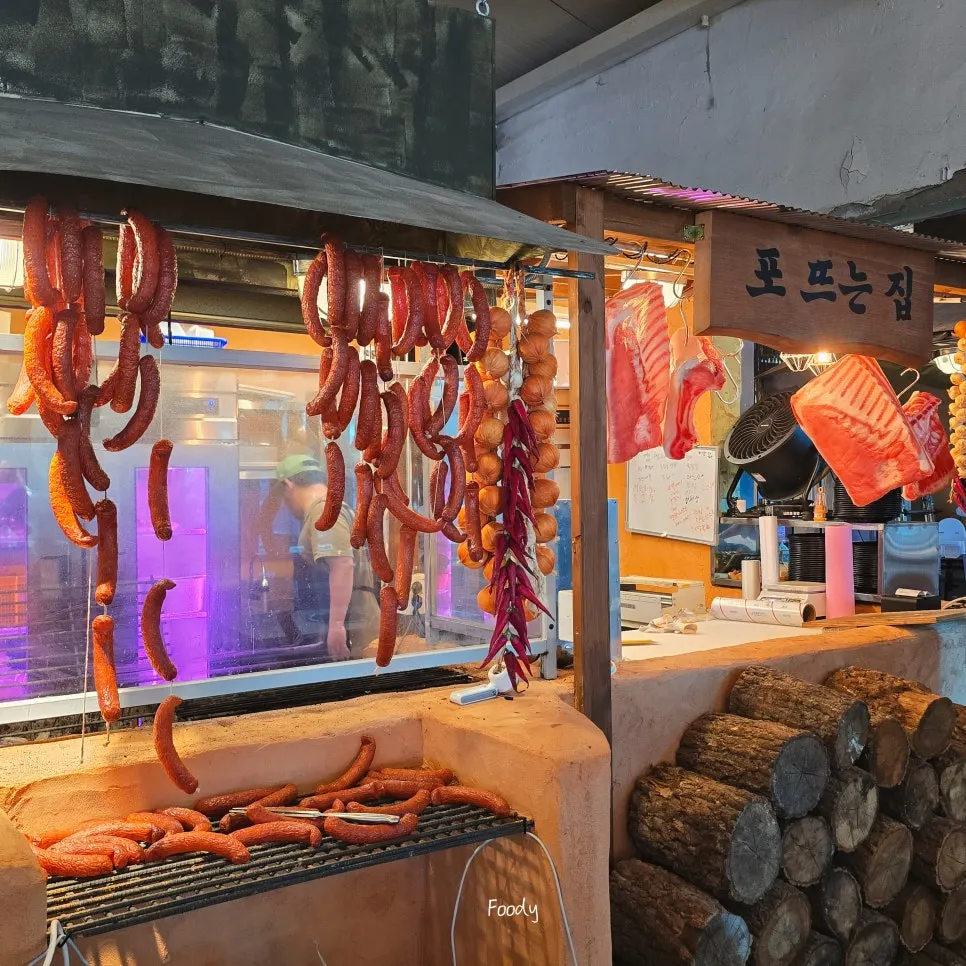 Central pre-grilling station with sausages hanging above