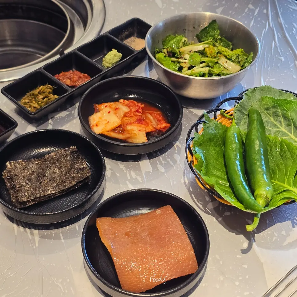 Table set with fresh cut kimchi and kimchi side dishes