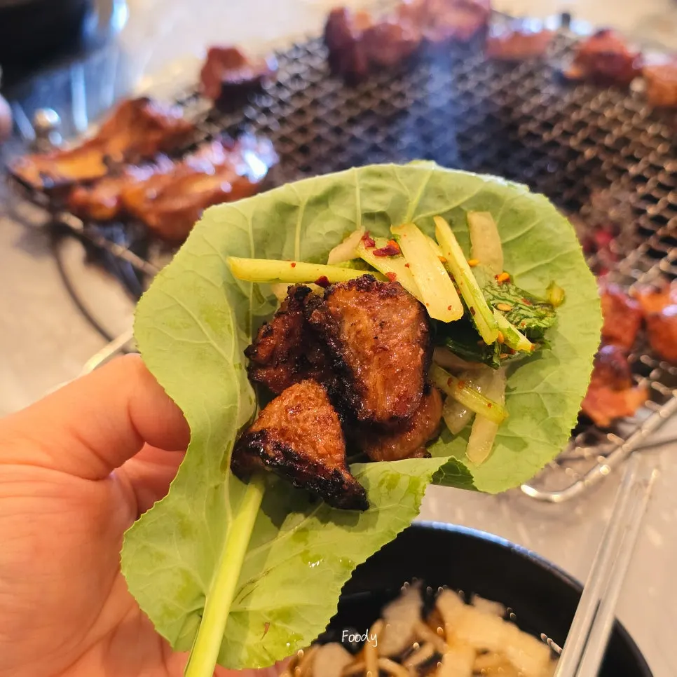 Pork galbi wrapped in a piece of kale