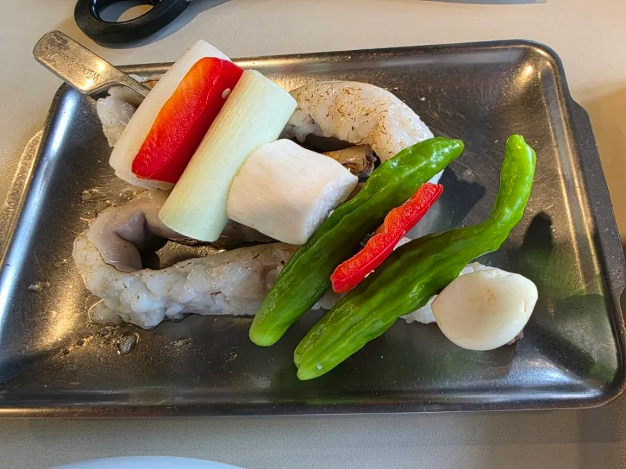 Staff grilling yangdaechang over charcoal
