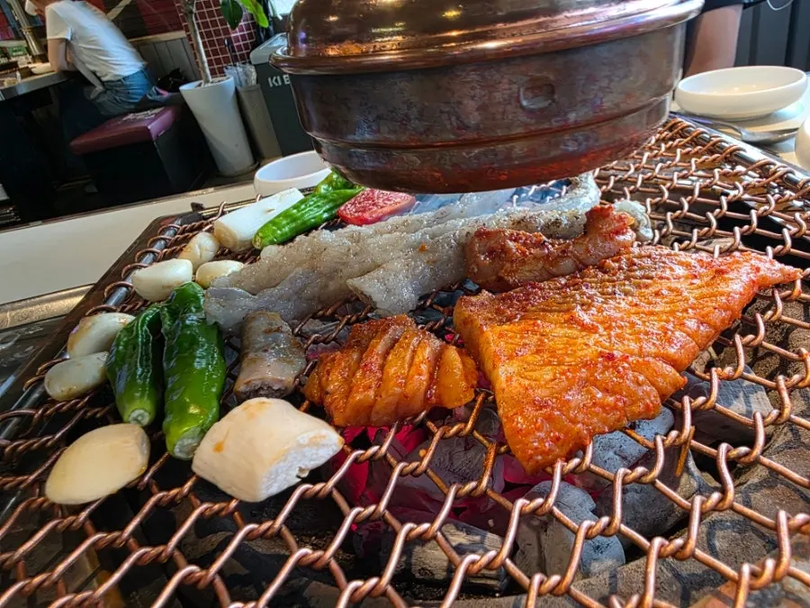 Daechang and gopchang cooking over charcoal
