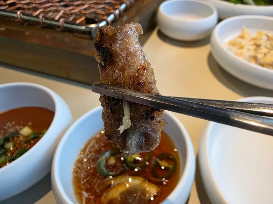 Korean beef gopchang grilling over charcoal