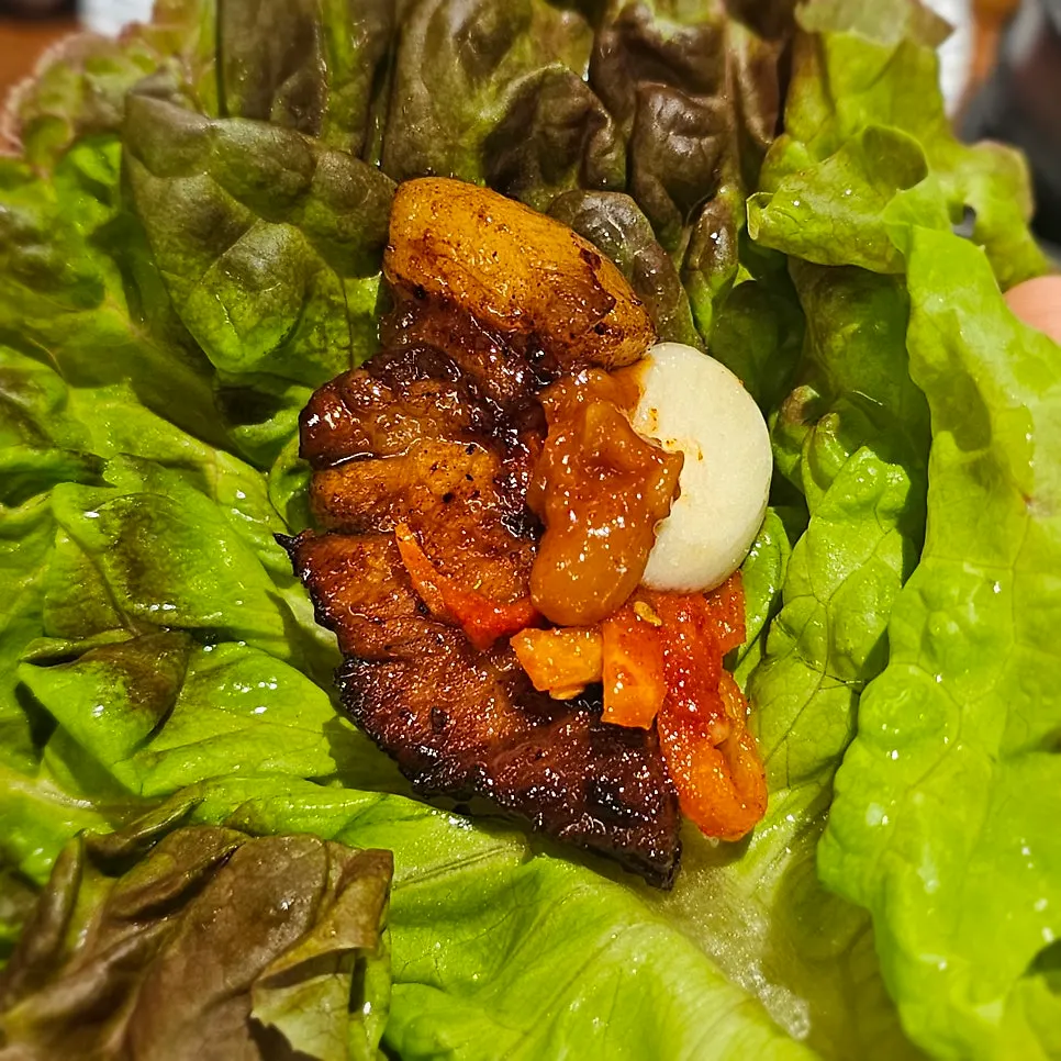 Lettuce wrap with meat, garlic, and fresh kimchi