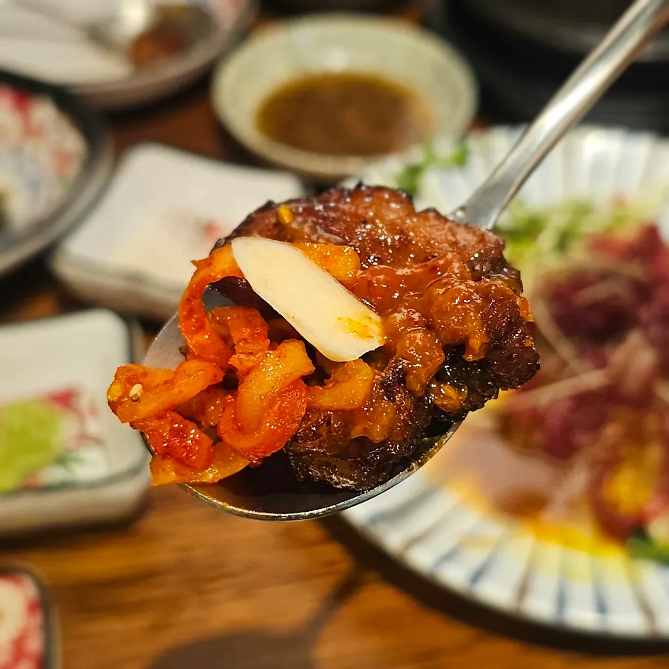 A spoonful of meat and side dishes in one bite