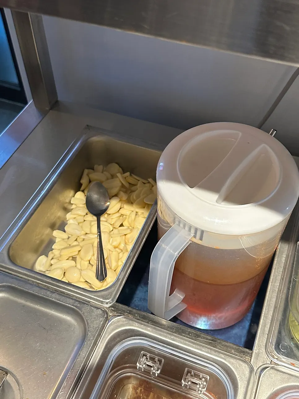 Close-up of tidy lids and utensils at the self-bar