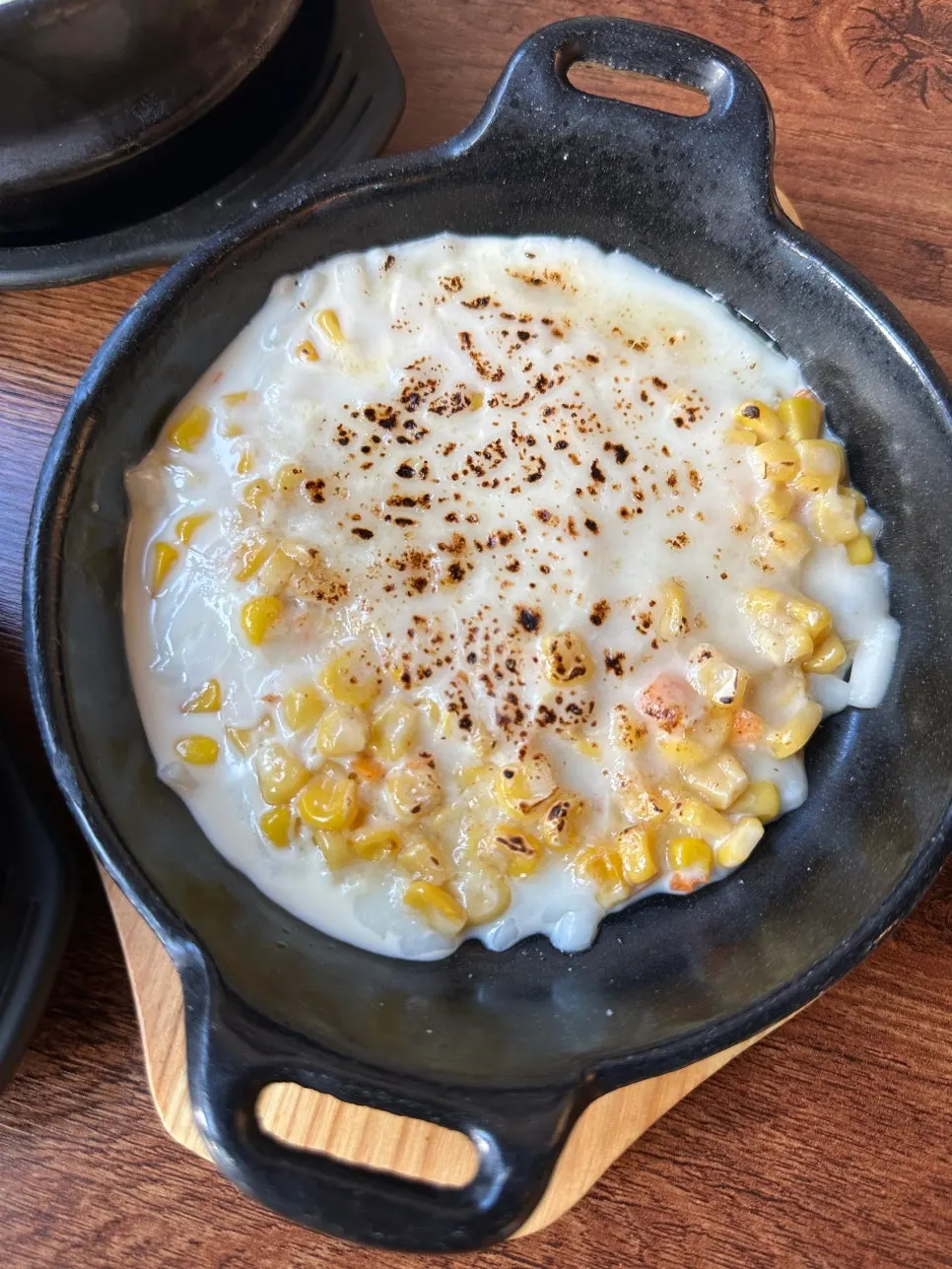Corn cheese mayo sizzling on a hot plate