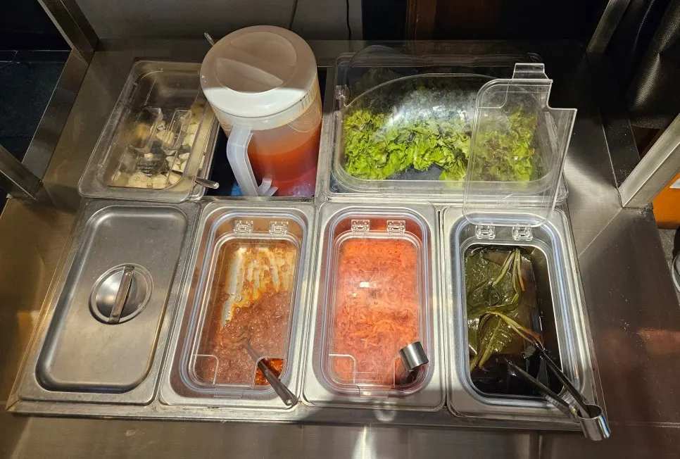 Self-serve bar at Baekseok Kkogijip stocked with sari noodles