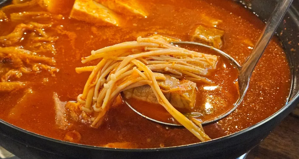 A pot of kimchi jjigae with sari noodles added