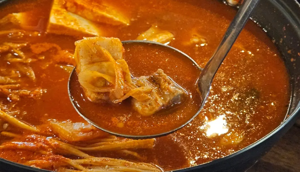 Kimchi jjigae packed with pork and enoki mushrooms