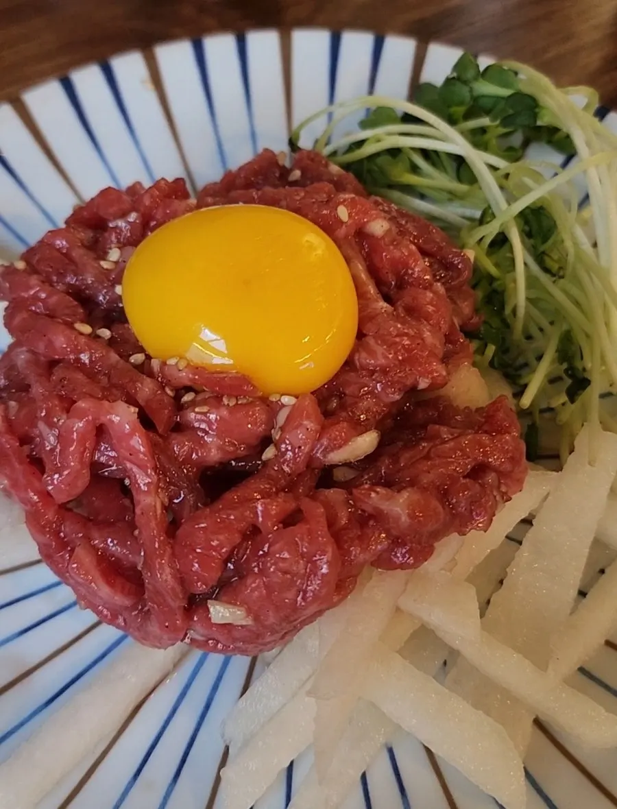 Complimentary beef tartare topped with egg yolk