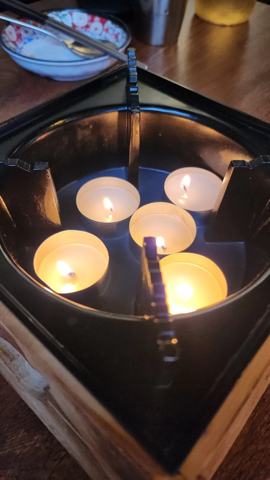 Cozy restaurant atmosphere with soft lighting and mini candles