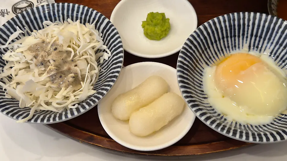 Cabbage, egg, and side dishes portioned into small plates