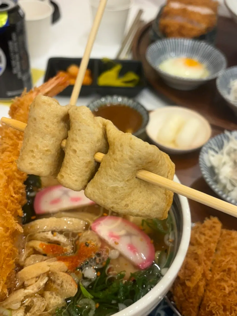 Udon bowl topped with shrimp tempura and fish cake