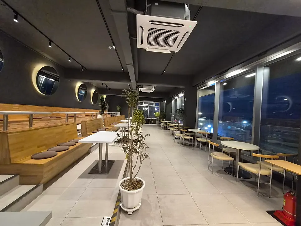 Ocean-view seating in the 2nd-floor NIGHT space at Baegya Coffee