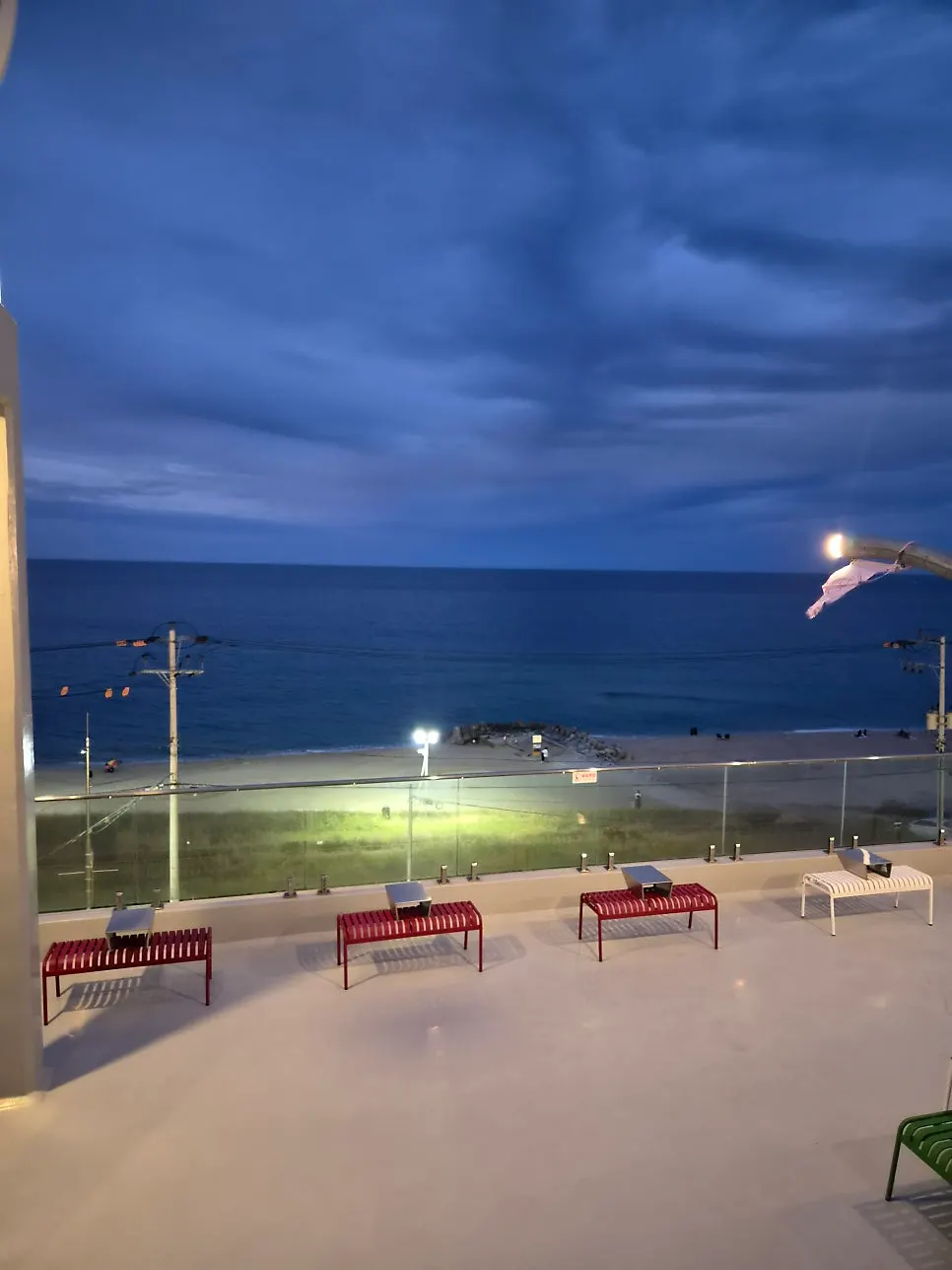 Terrace railing at Baegya Coffee with a view of Sageunjin Beach