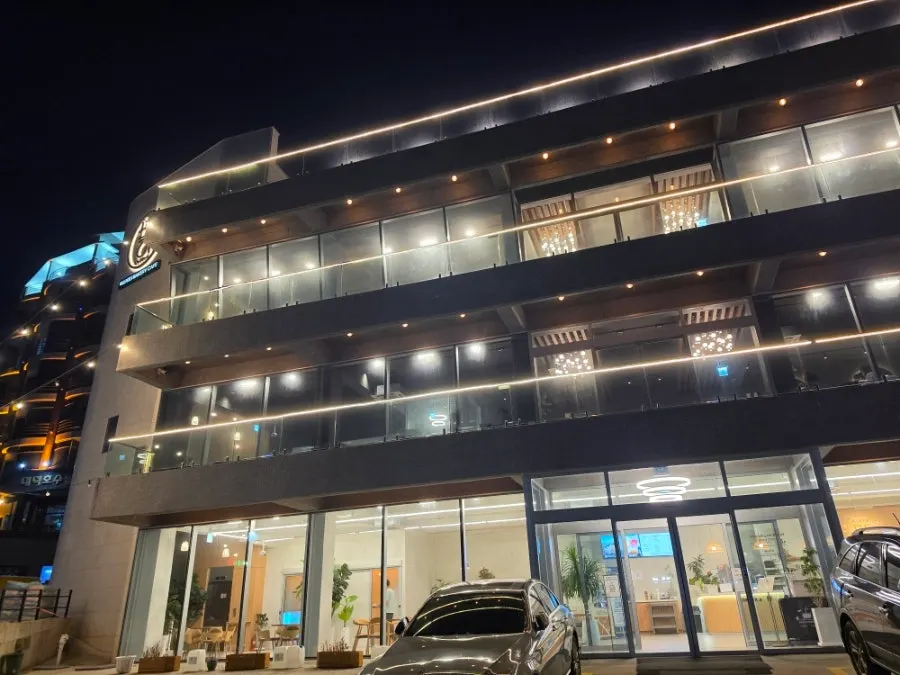Baegya Coffee building and parking lot seen at night