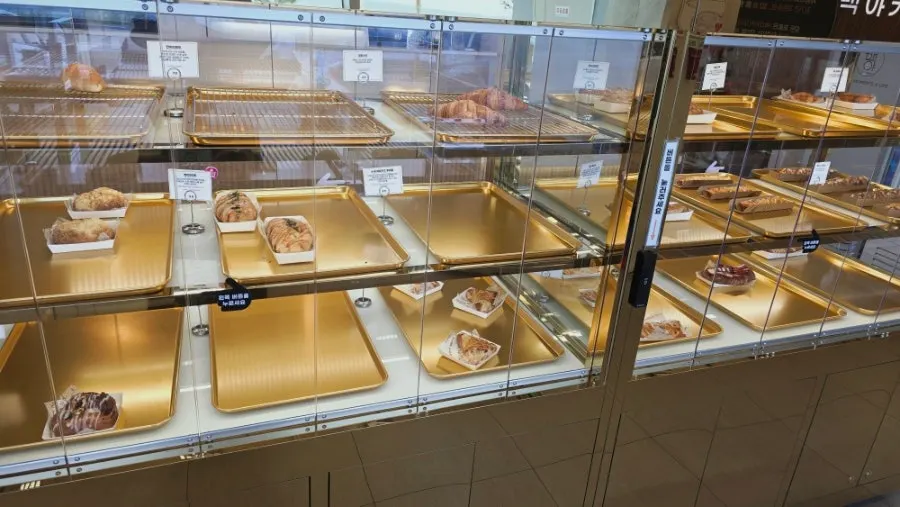 Bread shelf and price tags at Baegya Coffee