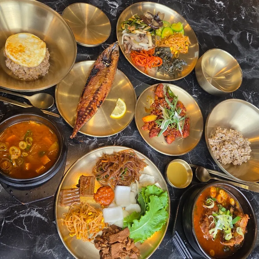 A tray loaded with side dishes and barley rice
