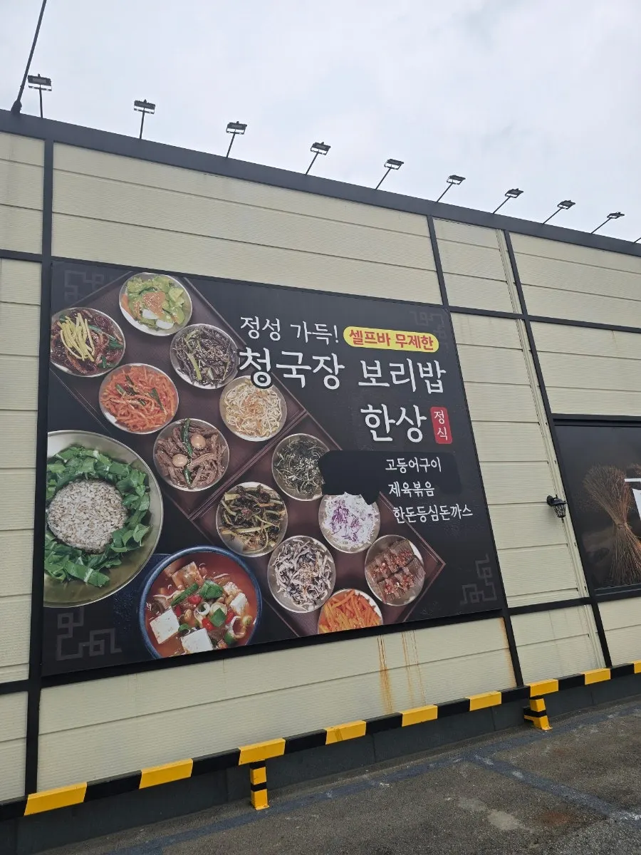 백년보리밥 외벽에 걸린 셀프바 무제한 안내 문구