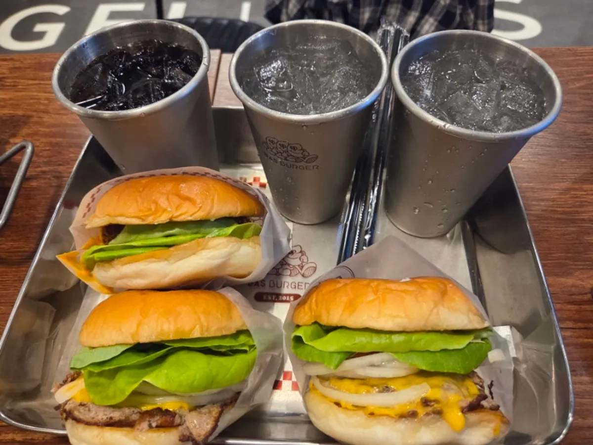 Table spread with the Bas Burger Set, Double Bas Burger Set, and Mozza Chicken Set for three