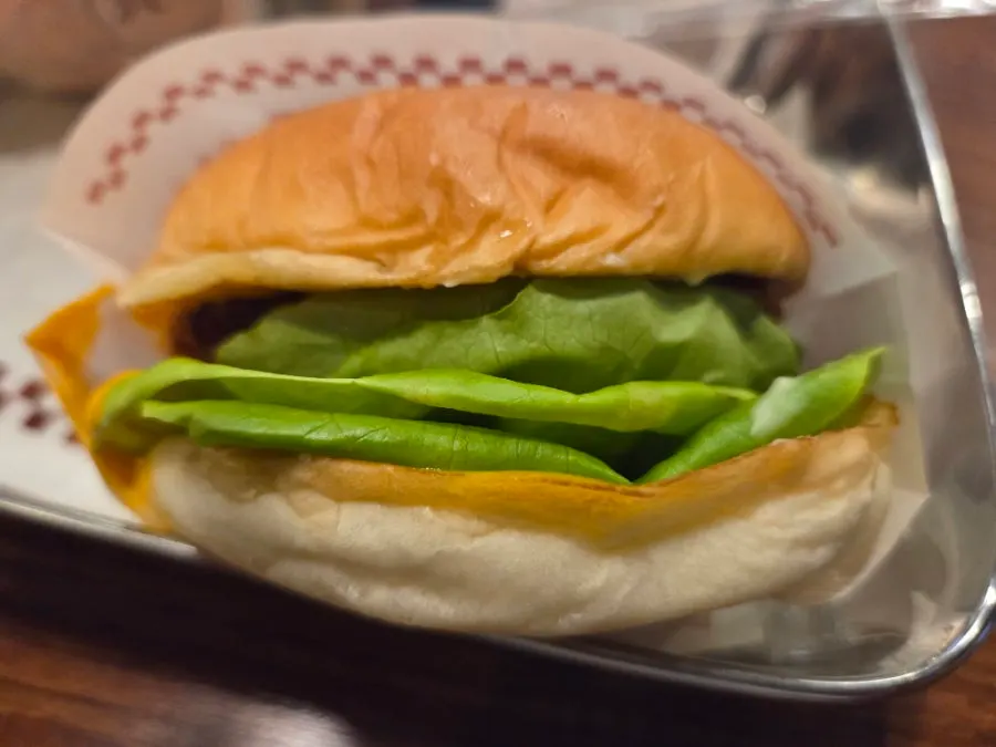 Close-up of a handmade burger with lettuce and onion