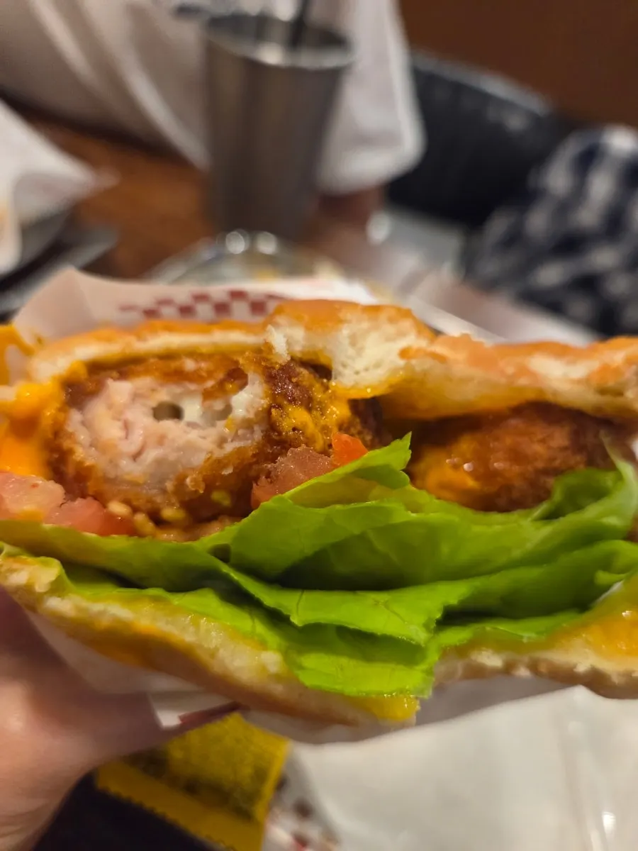 Eating the handmade burger hot and fresh in the store