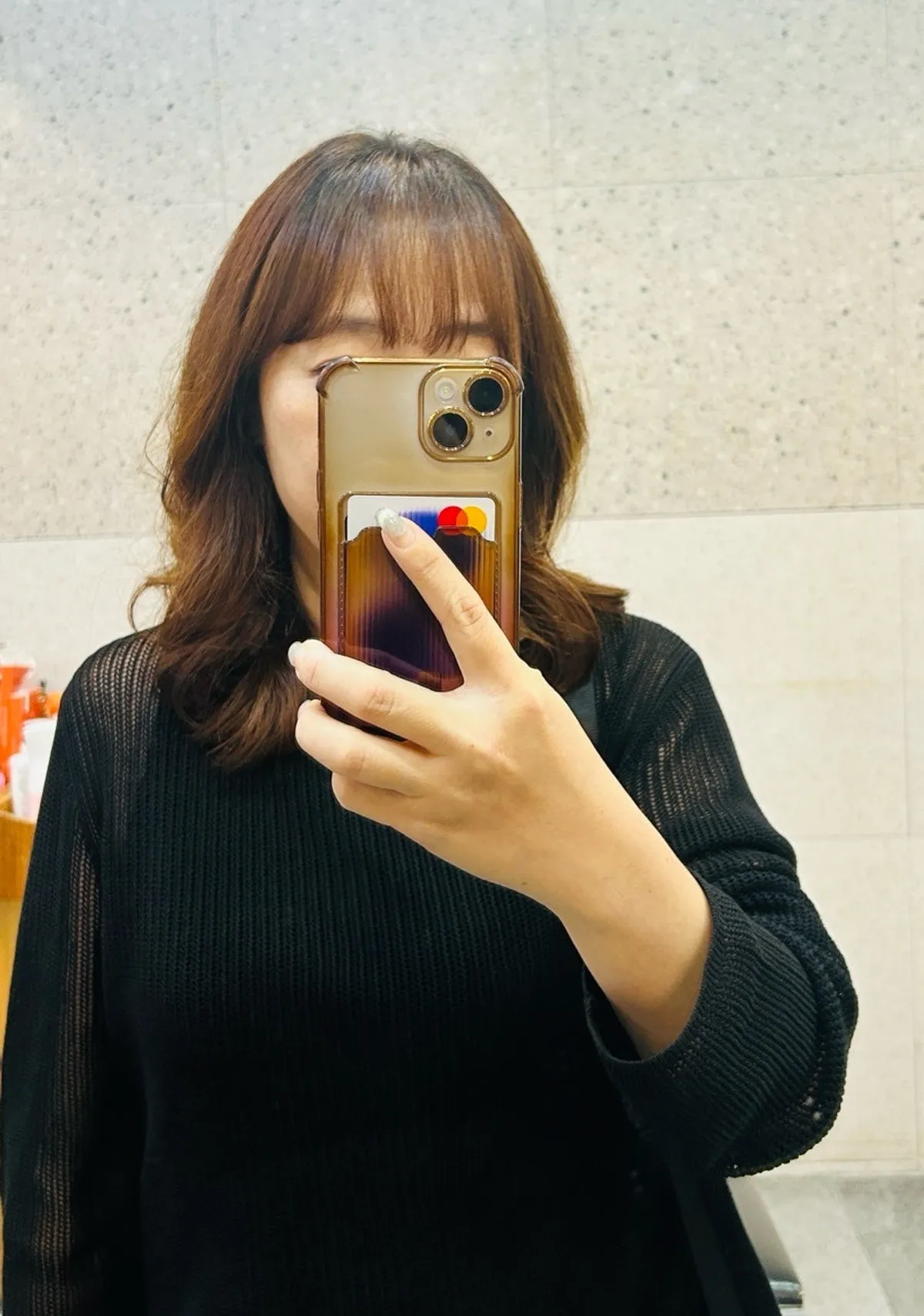 Collarbone-length hair after the finished layered build perm