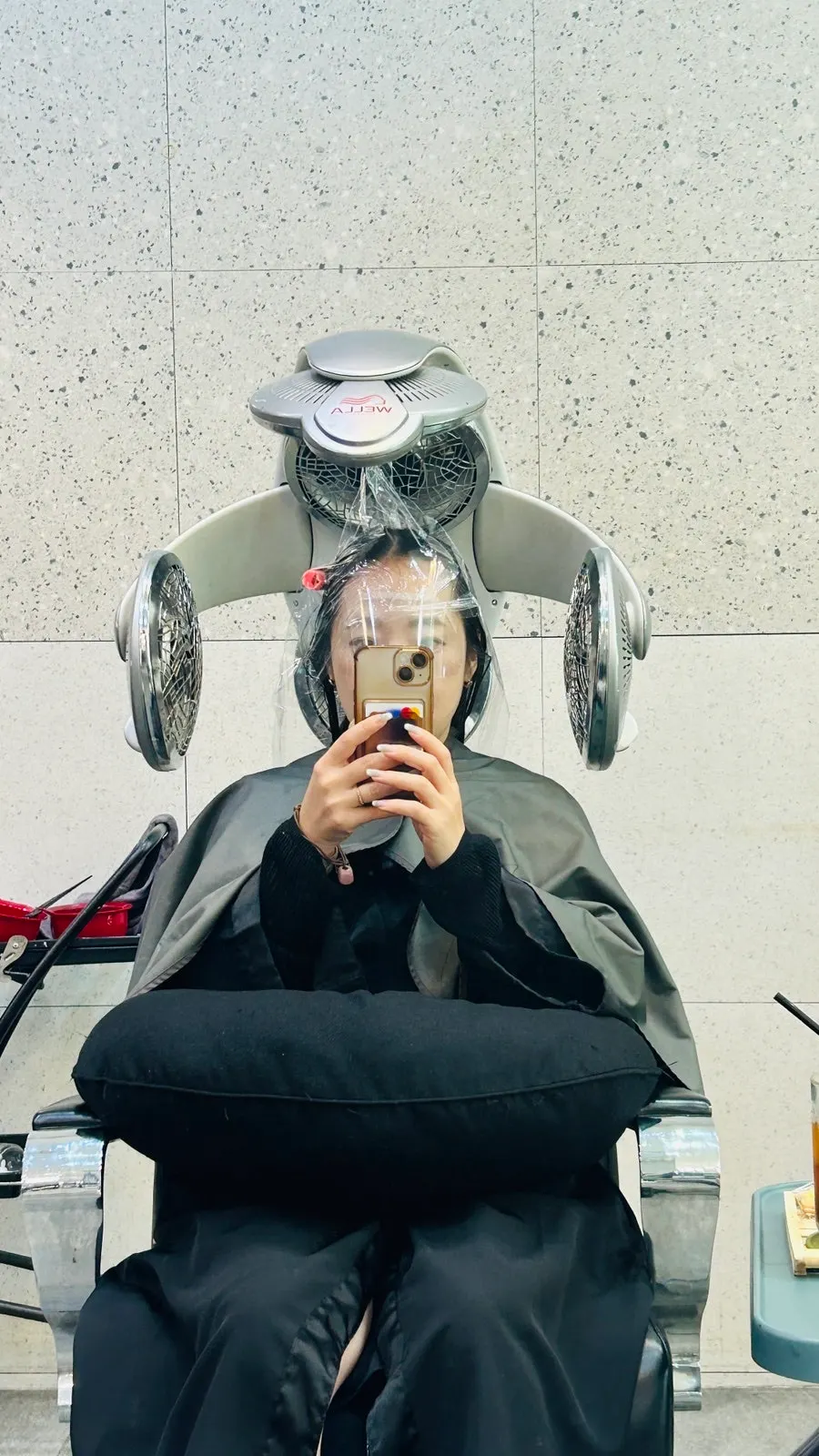 Hair being prepared for root straightening