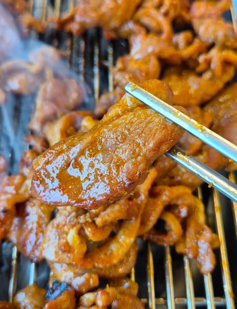 Red spicy stir-grilled duck cooking on the grill