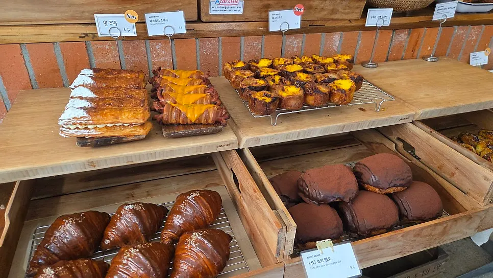 Display case of baked treats like financiers and madeleines